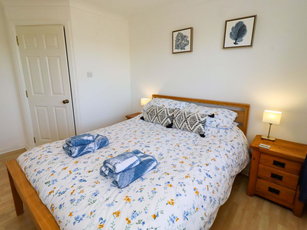 A bedroom with a bed and nightstand at 6 Westview in Embleton