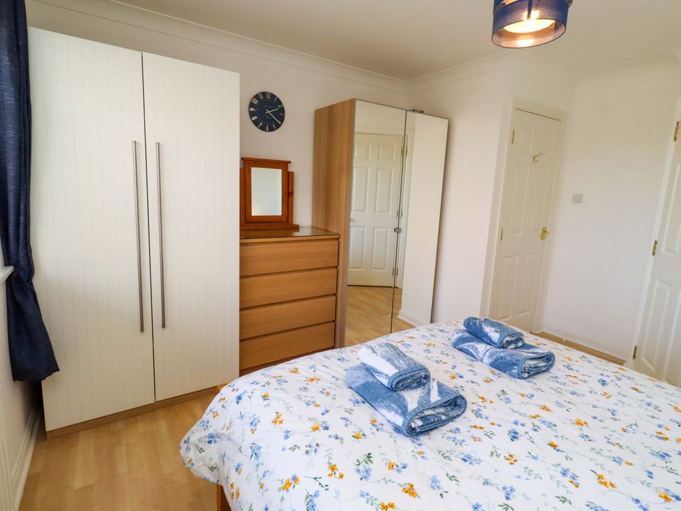 A bedroom with a wardrobe and chest of drawers at 6 Westview in Embleton