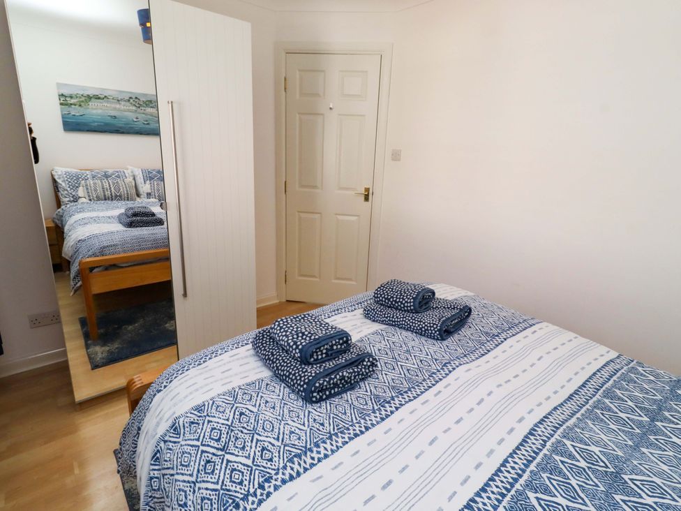 A bedroom with a bed and towels at 6 Westview in Embleton