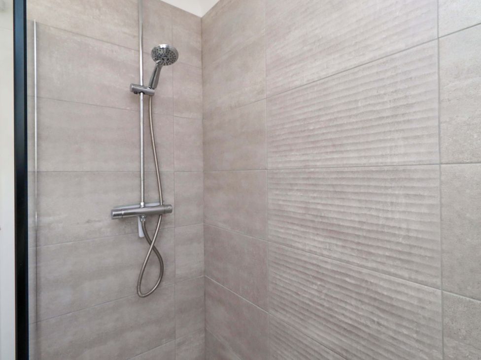 A shower with chrome fixtures and tiled walls at 6 Westview Embleton