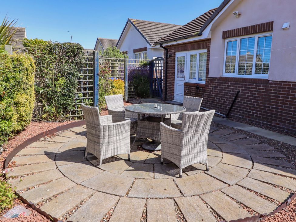 A patio area with a table and chairs at 6 Westview Embleton