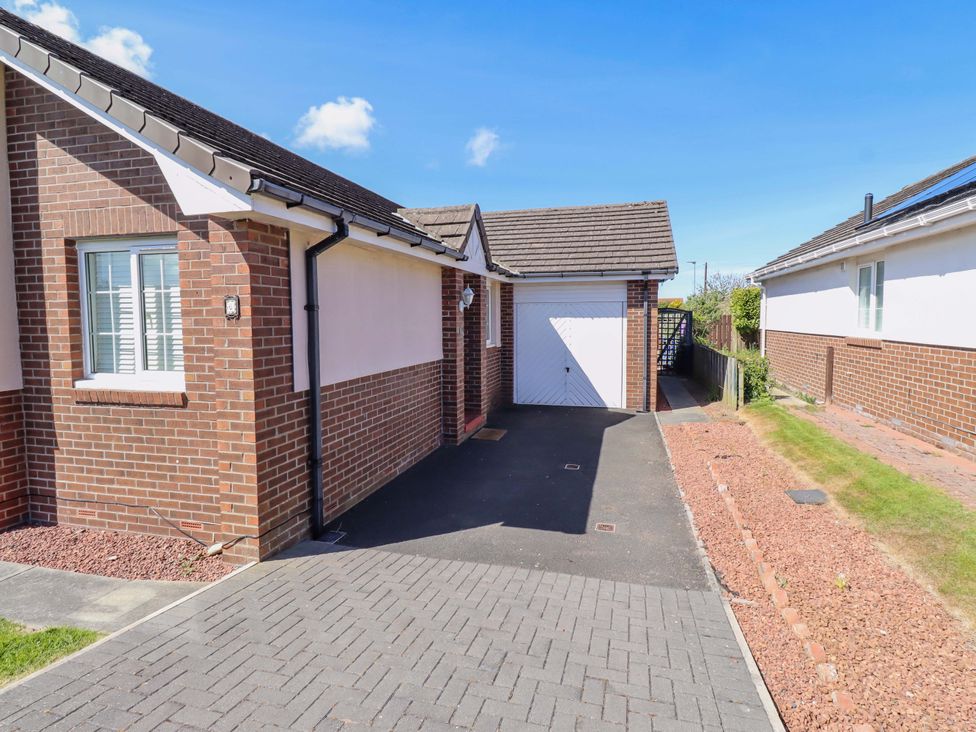 An outdoor view of a house with a garage and driveway at 6 Westview in Embleton