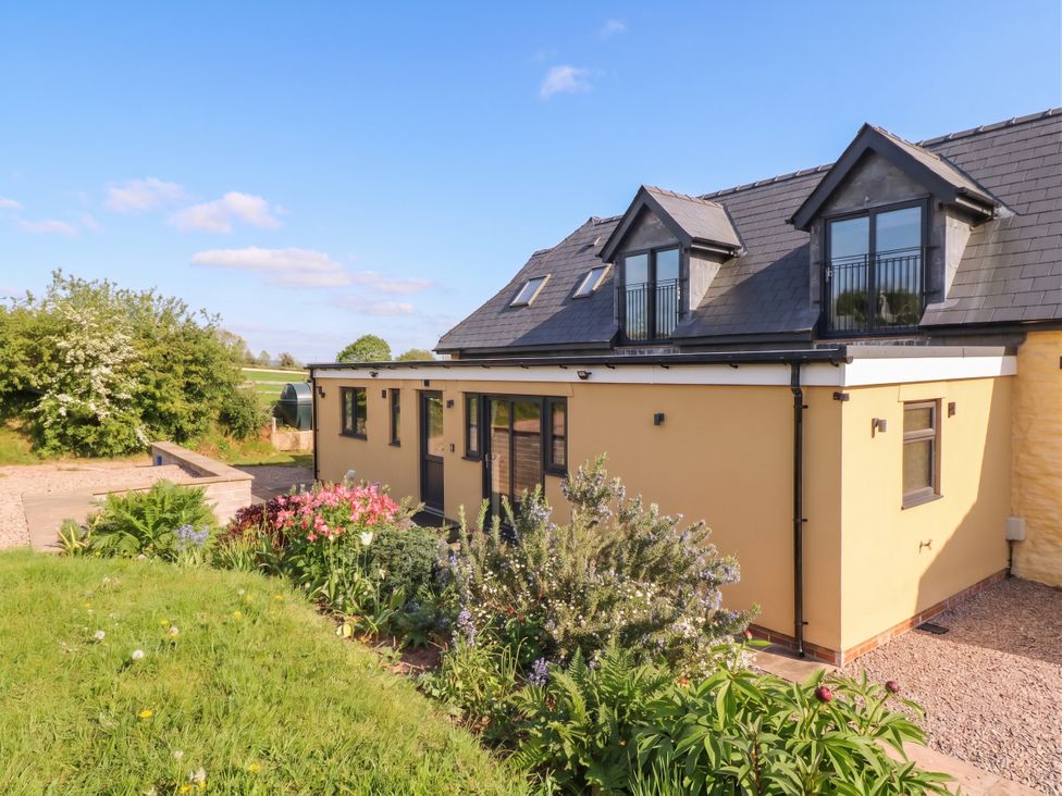 A house with plants and gravel outside at Palace Farmhouse in St Weonards