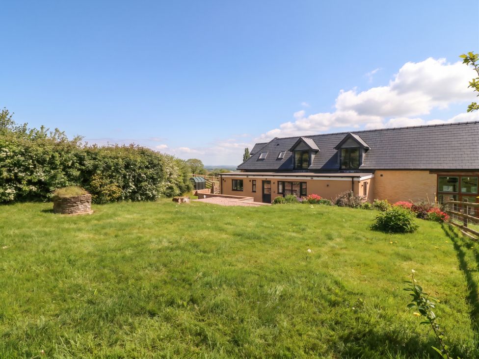 An outdoor space with a house and garden at Palace Farmhouse St Weonards