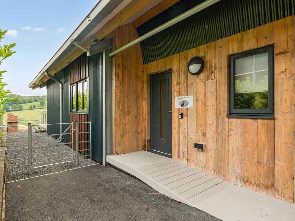 An entrance area with door and gate at Bwncath in Garthmyl