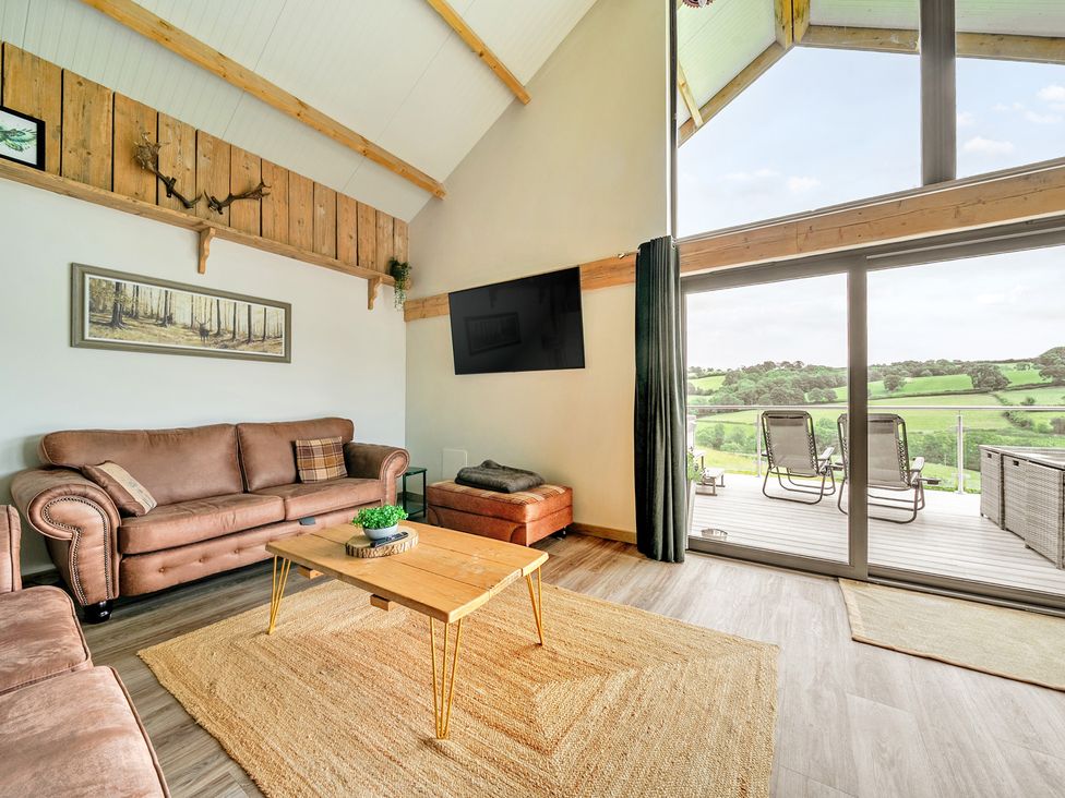 A living room with a sofa and coffee table at Bwncath in Garthmyl