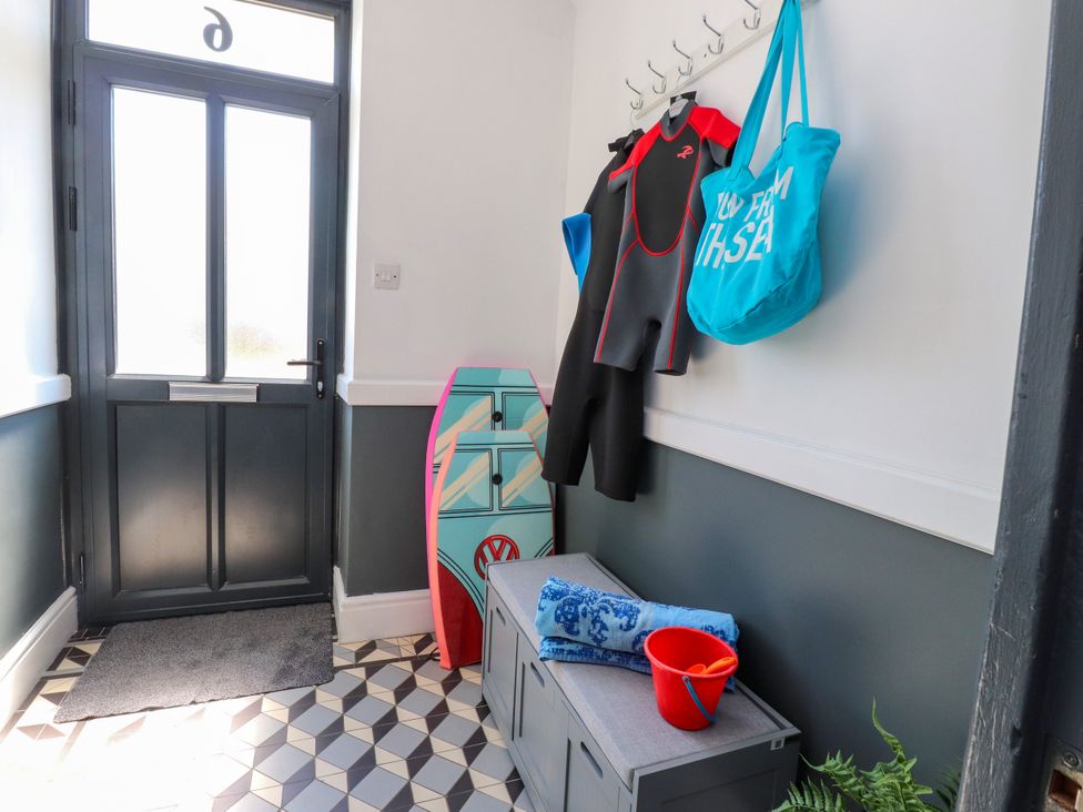 A hallway with a wetsuit and beach gear at Ty Haul in Rhosneigr