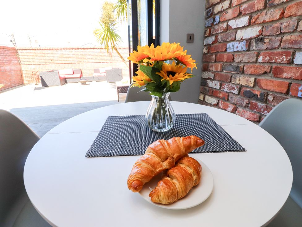 A dining room with a table and croissants at Ty Haul in Rhosneigr