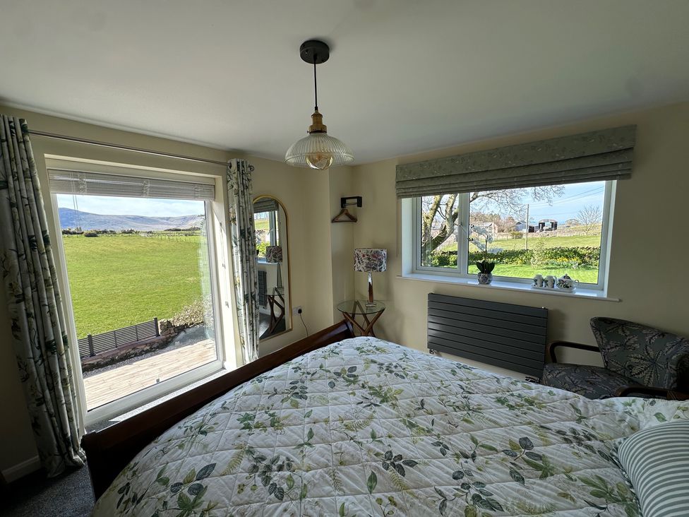 A bedroom with a bed and window at How Hill Farm Cottage Greystoke
