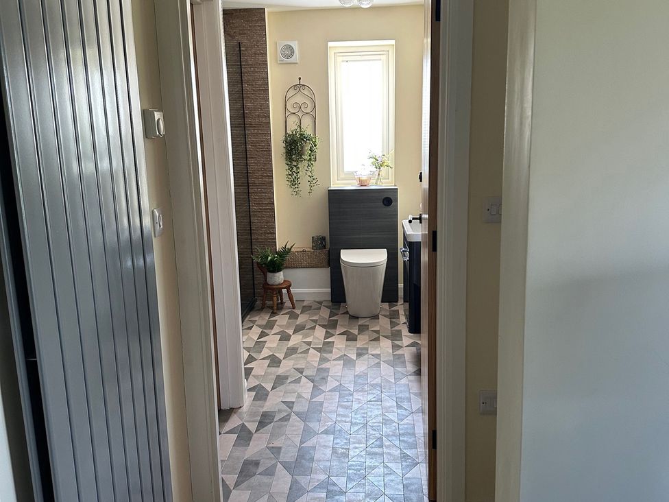 A bathroom with a toilet and sink at How Hill Farm Cottage in Greystoke
