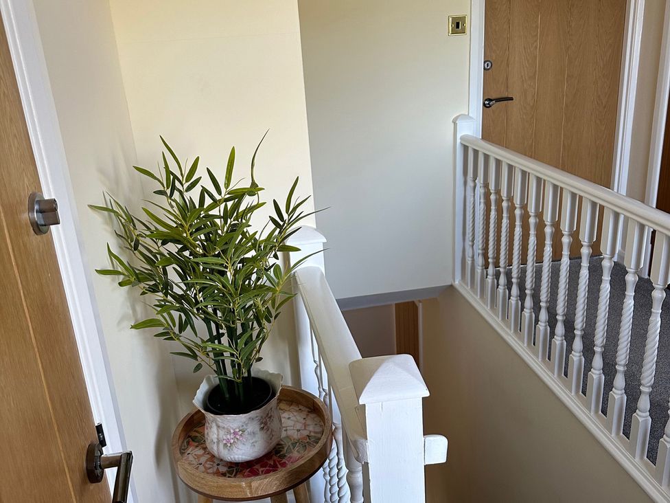 A hallway with a plant on a tray at How Hill Farm Cottage in Greystoke