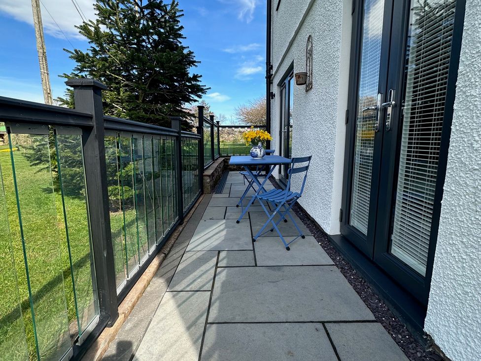 An outdoor area with a table and chairs at How Hill Farm Cottage in Greystoke