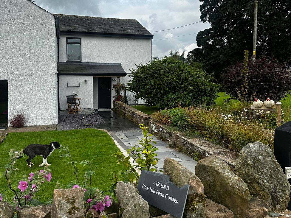 A house with a garden and pathway at How Hill Farm Cottage Greystoke