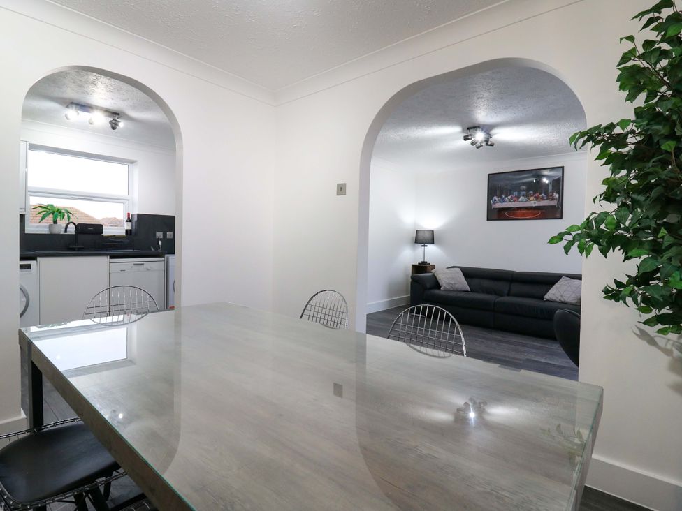 A dining room with a table and chairs at 79 Selsey Avenue 