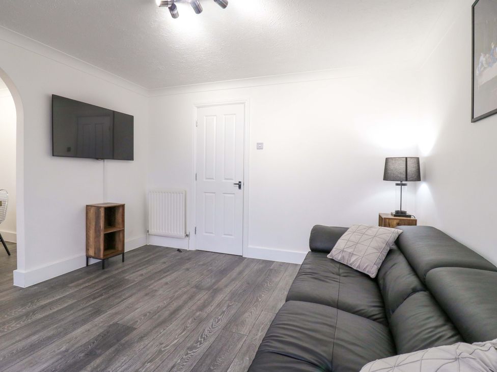 A living room with a television and sofa at 79 Selsey Avenue