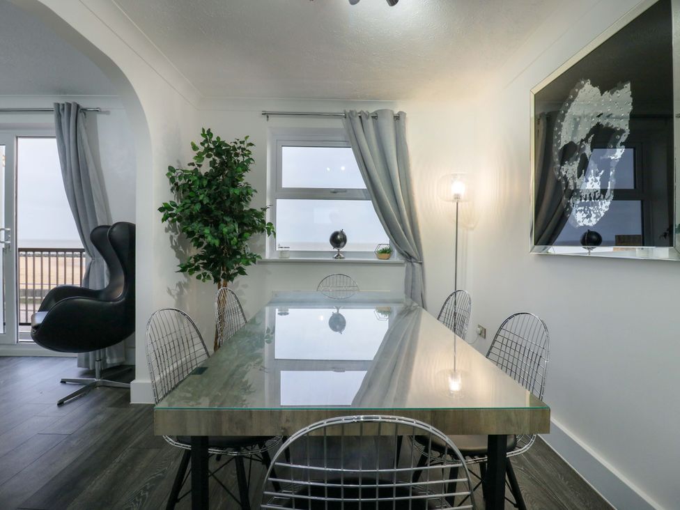 A dining room with a table and chairs at 79 Selsey Avenue
