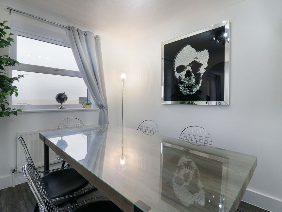 A dining room with a table and chairs at 79 Selsey Avenue