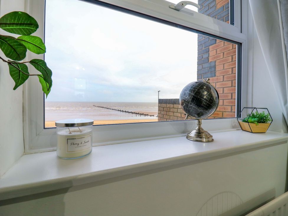 A window with a view of the sea and decorative items at 79 Selsey Avenue 