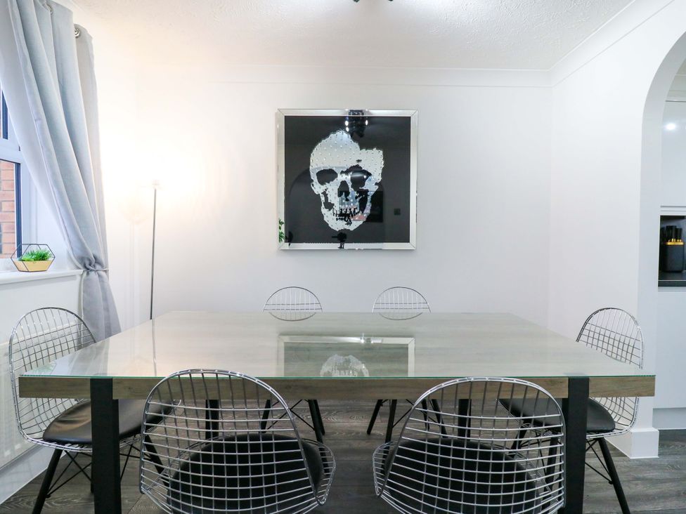 A dining room with a table and chairs at 79 Selsey Avenue