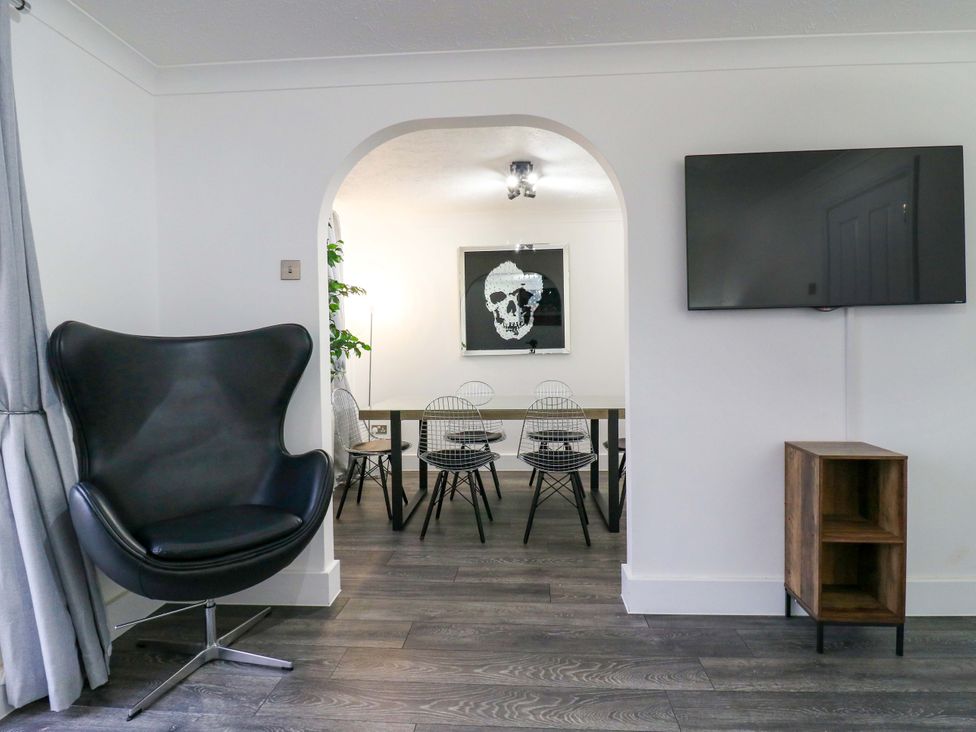 A living room with an armchair and television at 79 Selsey Avenue