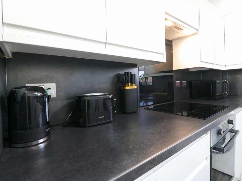 A kitchen with appliances including a kettle, toaster, and knife block at 79 Selsey Avenue