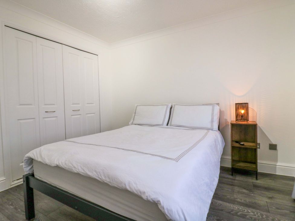 A bedroom with a bed and a wardrobe at 79 Selsey Avenue