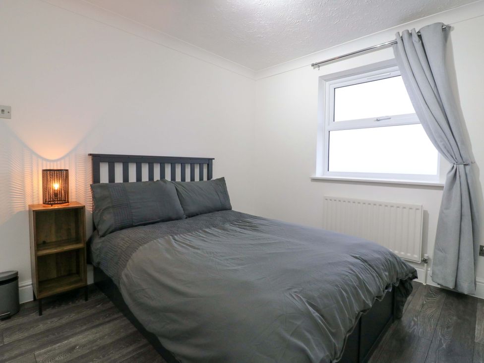 A bedroom with a bed and nightstand at 79 Selsey Avenue 