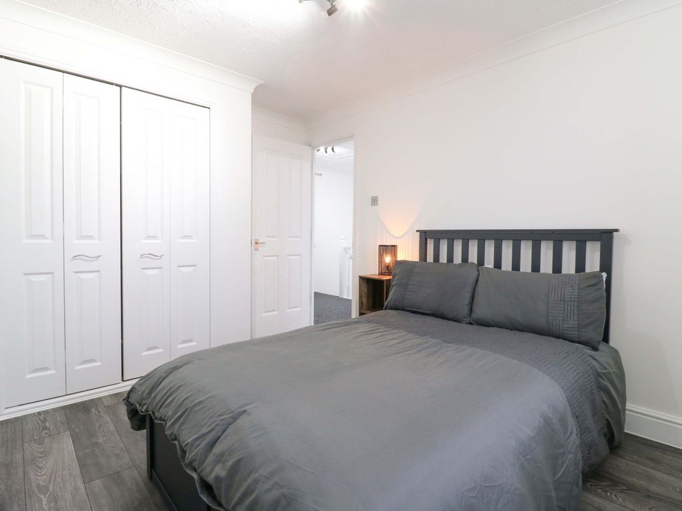 A bedroom with a bed and wardrobe at 79 Selsey Avenue