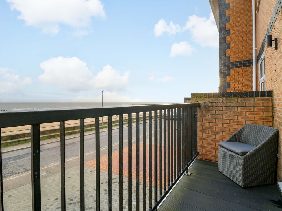 A balcony with a chair overlooking the ocean at 79 Selsey Avenue