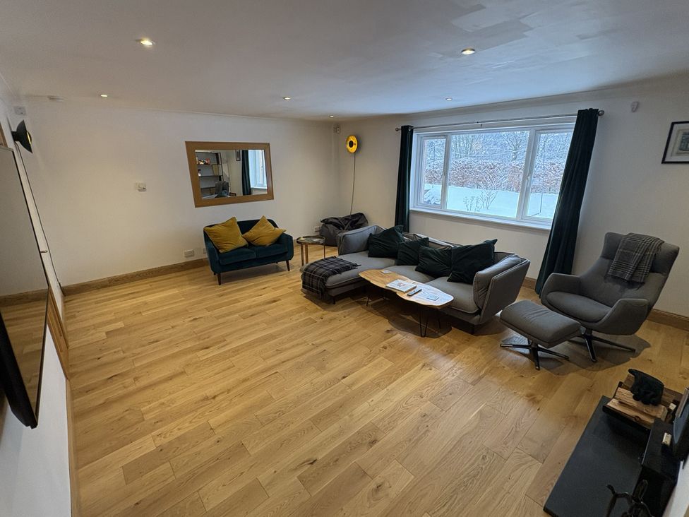 A living room with a sofa and coffee table at Mullingar in Pitlochry
