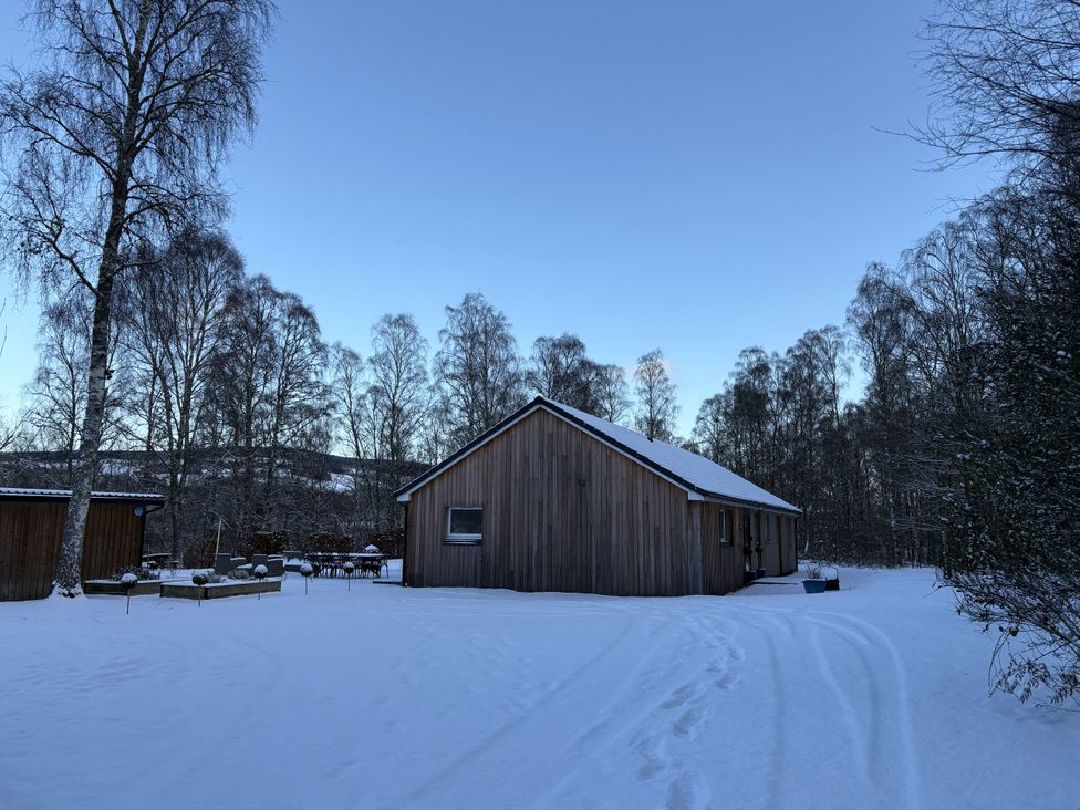 A house in snow with trees and driveway at Mullingar in Pitlochry