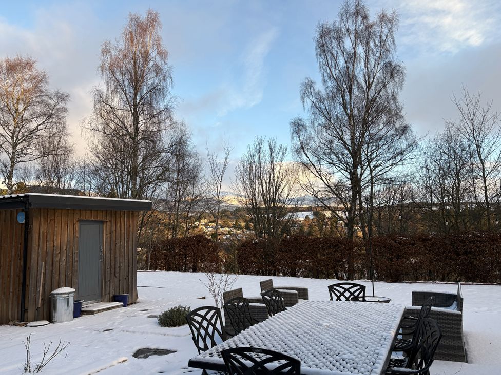 An outdoor area with a table and chairs in snow at Mullingar in Pitlochry