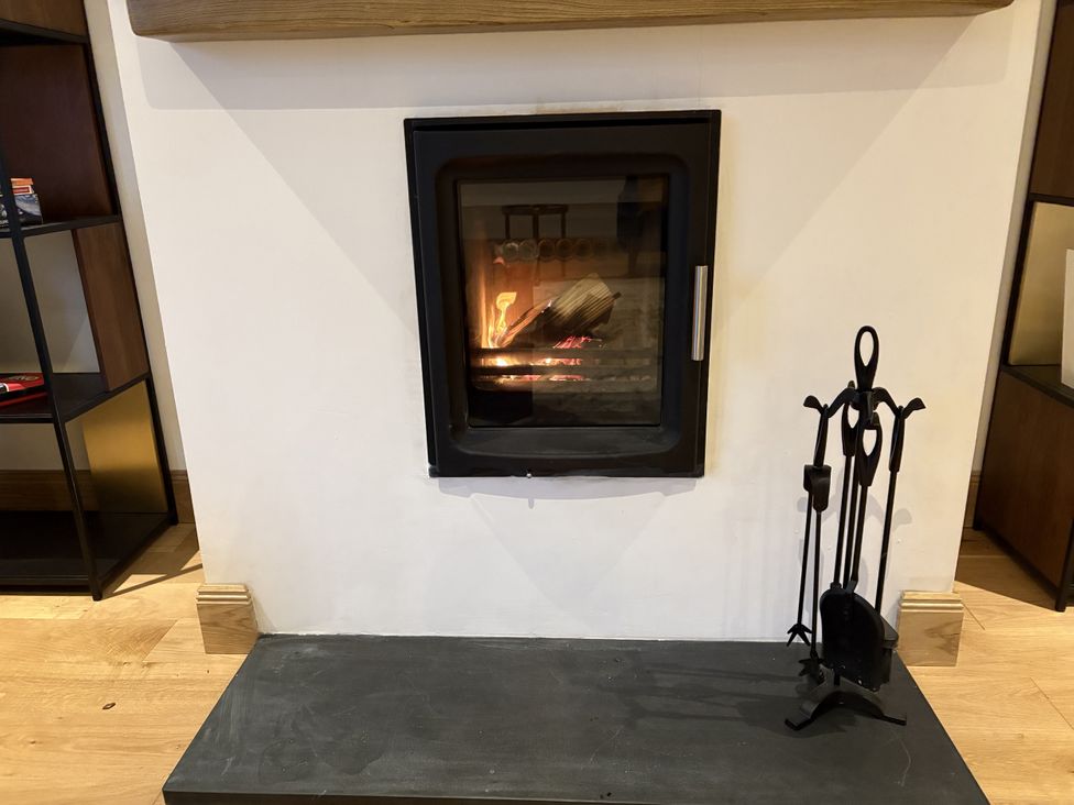 A fireplace with firewood and tools at Mullingar in Pitlochry