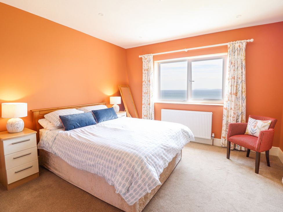 A bedroom with a bed and side table at Bryn Mor in Benllech