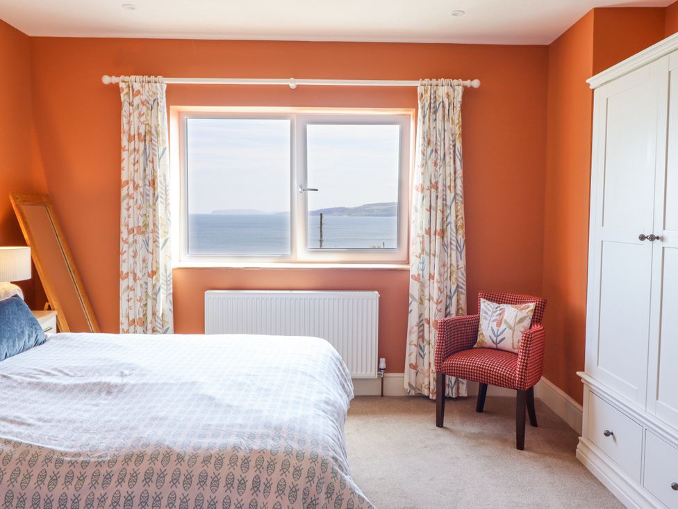 A bedroom with a window facing the sea at Bryn Mor in Benllech
