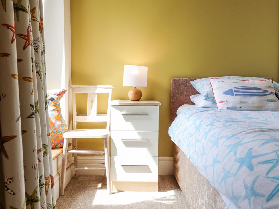 A bedroom with a bed and bedside table at Bryn Mor in Benllech