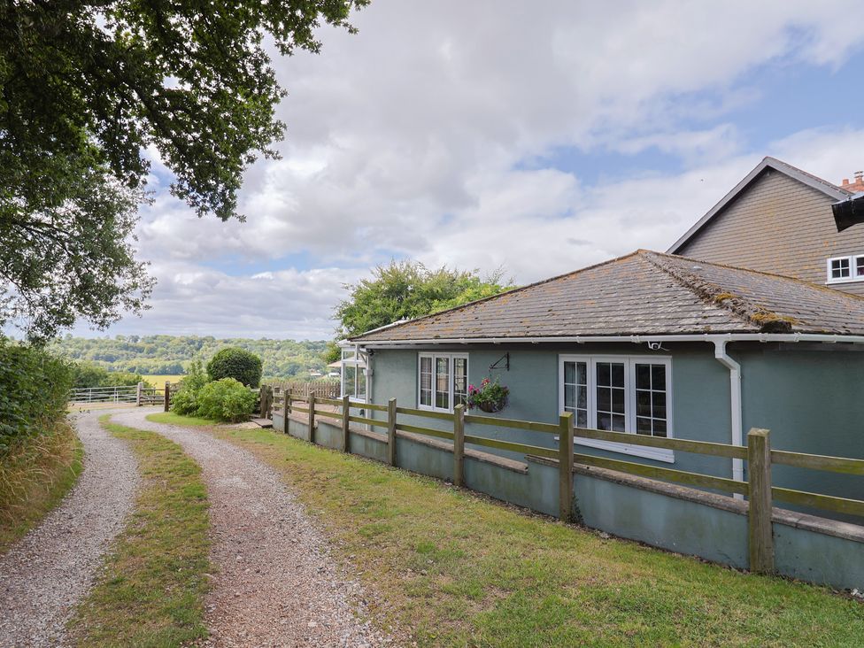 A house with a pathway and trees at Rainbow View in Churchstanton near Churchinford