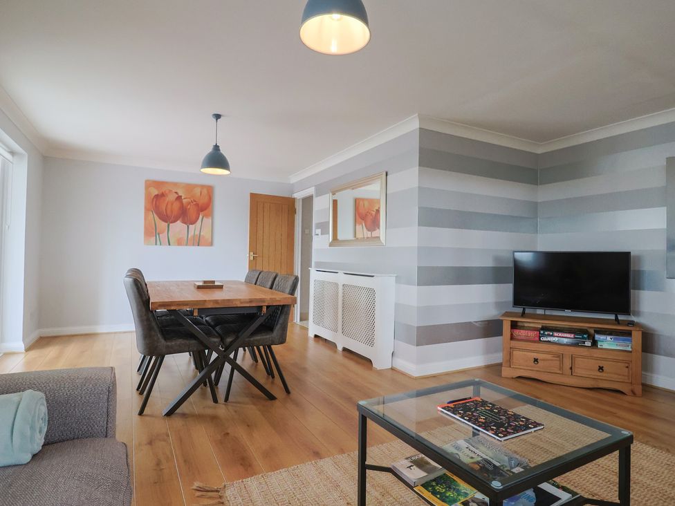 A dining room with a table and chairs at Rainbow View in Churchstanton near Churchinford