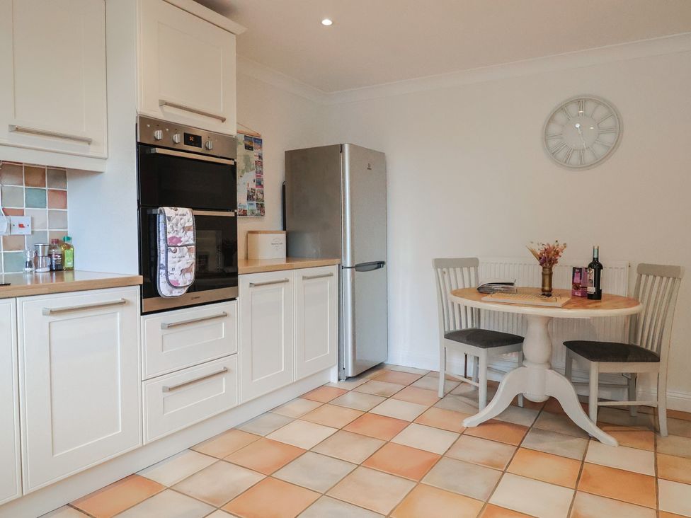 A kitchen with a table and chairs at Rainbow View in Churchstanton near Churchinford