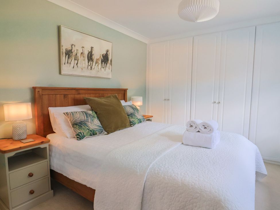 A bedroom with a bed and nightstand at Rainbow View Churchstanton near Churchinford