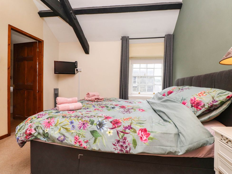A bedroom with a bed and television at 11- 13 High Street