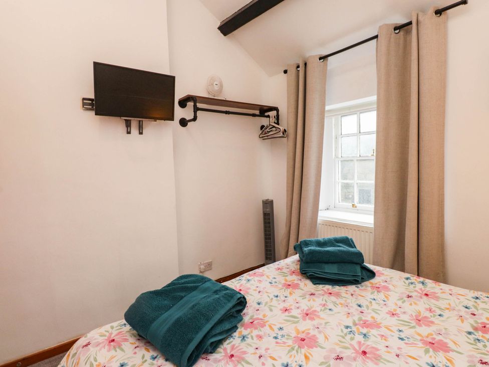 A bedroom with a bed and television at 11- 13 High Street