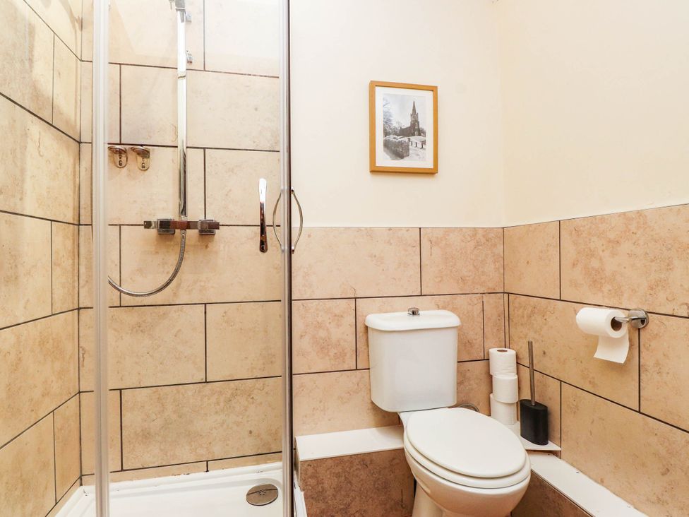 A bathroom with a shower and toilet at 11- 13 High Street