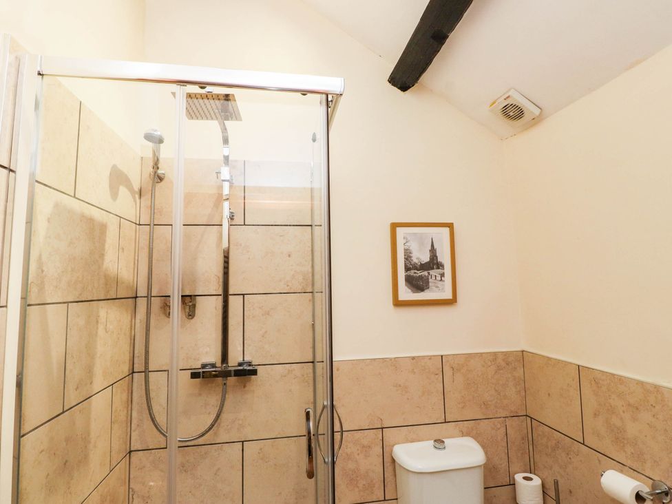 A bathroom with a shower and toilet at 11- 13 High Street