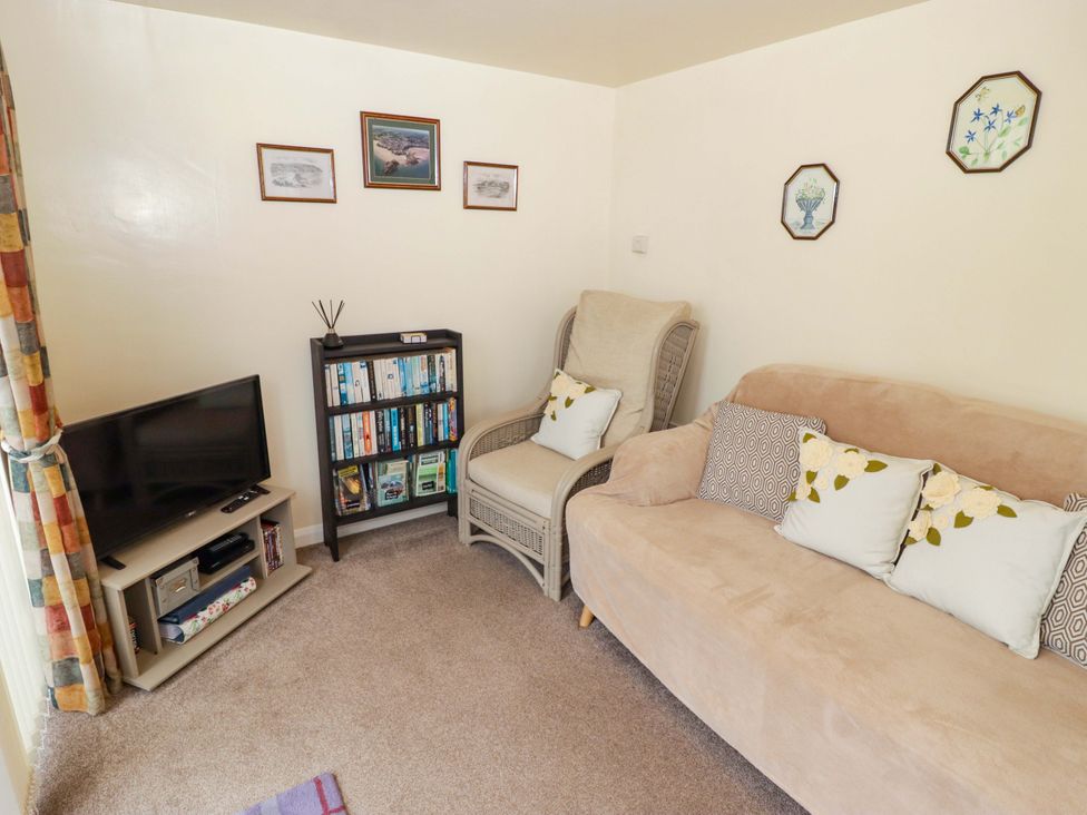 A living room with a sofa and television at Penn Lea in Penally