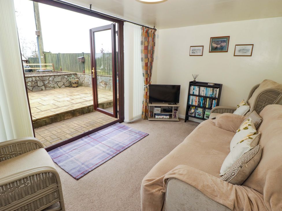 A living room with a sofa and television at Penn Lea in Penally