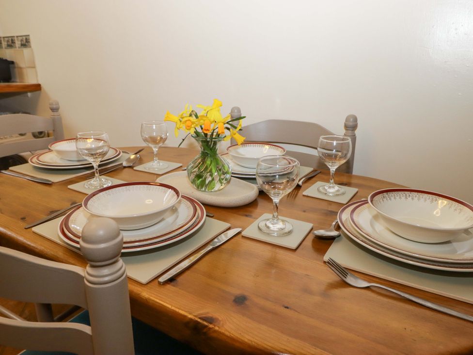 A dining table set with plates and glasses at Penn Lea in Penally