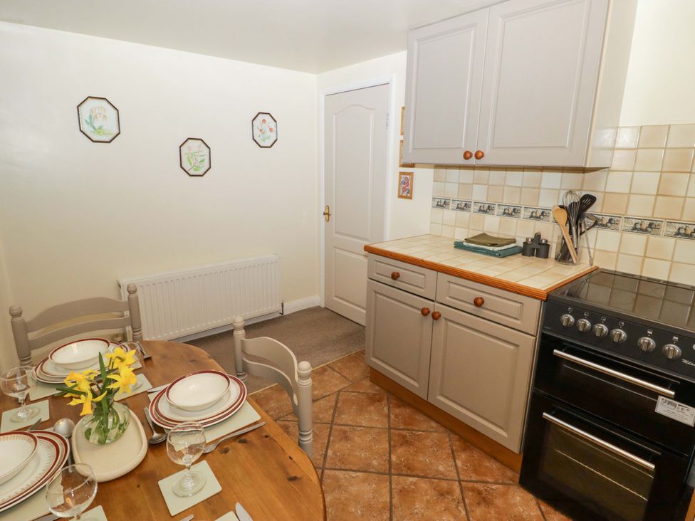 A kitchen with a dining table and stove at Penn Lea in Penally
