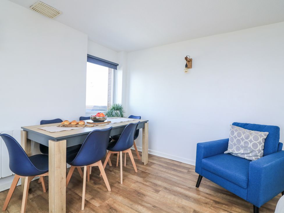 A dining room with a table and chairs at Sunset Sea View Chalet in Millbrook