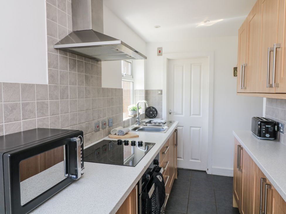 A kitchen with cabinets and appliances at Sunset Sea View Chalet in Millbrook